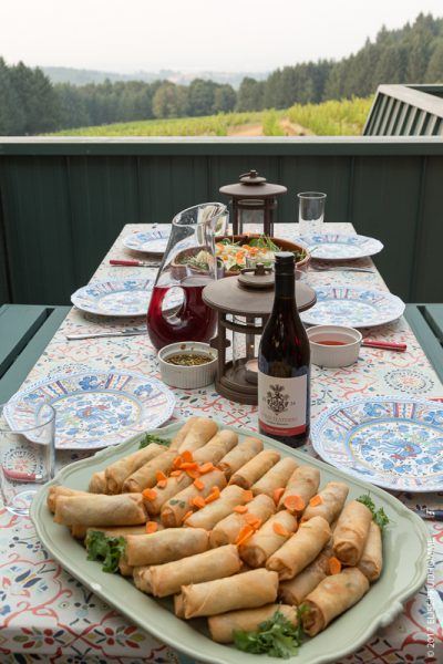 Cynthia's spring rolls served with Three Feathers Estate 2016 Pinot Noir with view of vineyards in background.
