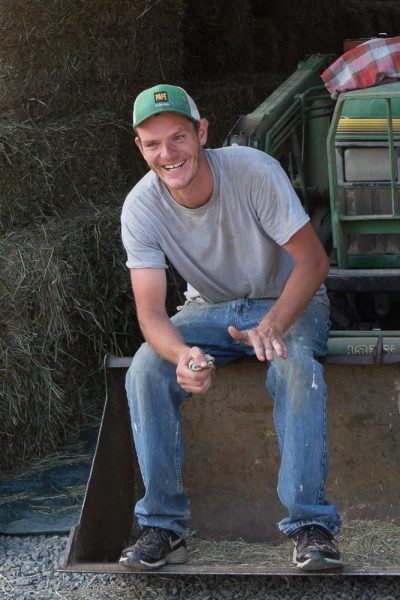 David sits on a John Deere shovel and takes a break during hay season on Three Feathers Estate & Vineyard, Chehalem Mountain, Oregon.