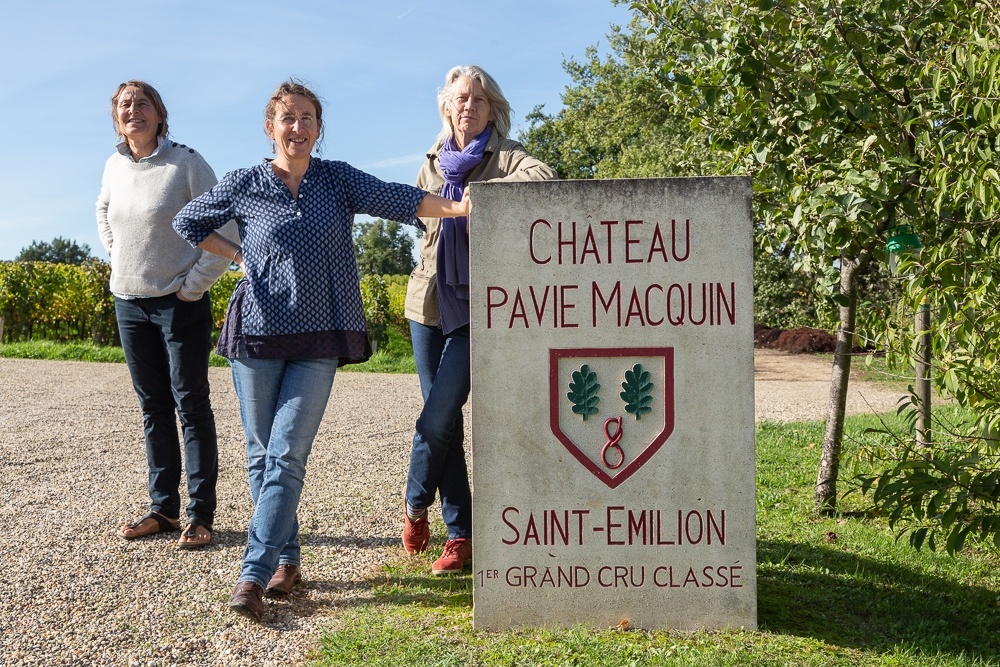 Group portrait next to the stele of Chateau-Pavie-Macquin, Saint-Emilion, Bordeaux region, Department of the Gironde, France.